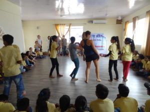 slum childrenand yoga teacher training students 