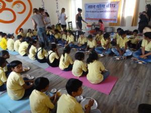 slum childrenand yoga teacher training students