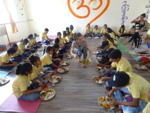 yoga teacher training students and slum children