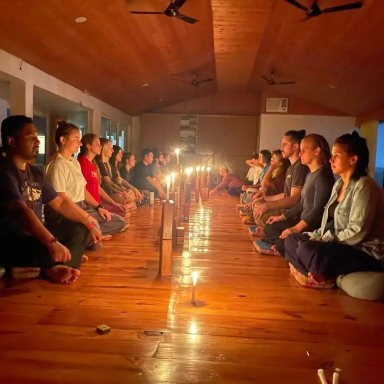 Yoga students participating in an emotional blockage treatment session inside a yoga hall